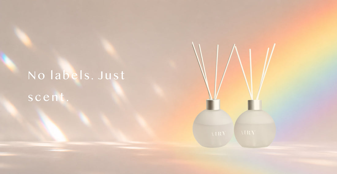Two AIRY® Fragrances reed diffusers in identical frosted glass bottles against a soft rainbow light background, representing genderless home fragrance designed for every person, AIRY® Fragrances .