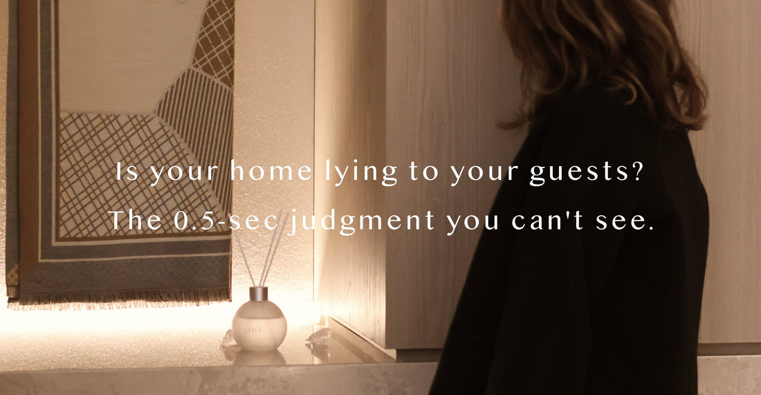 Airy designer reed diffuser acting as a silent social marker in a luxury British entryway, creating an expensive and refined atmosphere that defines the 0.5-second first impression of a high-end home.