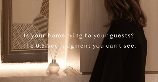 Airy designer reed diffuser acting as a silent social marker in a luxury British entryway, creating an expensive and refined atmosphere that defines the 0.5-second first impression of a high-end home.