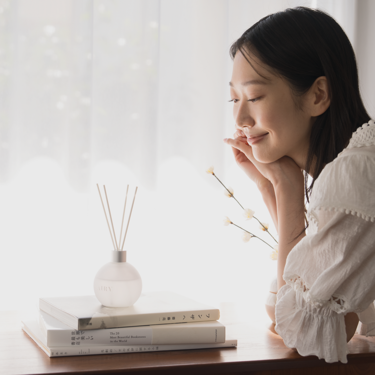 Woman enjoying Airy Fragrances Japanese reed diffuser — Elegant Harmony 優 home fragrance, crafted in Japan, alcohol-free