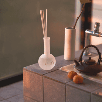 Image showcasing a collection of home fragrances designed for tea aficionados, featuring Japan's finest tea scents such as exquisite jasmine and creamy Jin Xuan. The products are presented to transform any space into a luxurious, delightful oriental spa atmosphere
