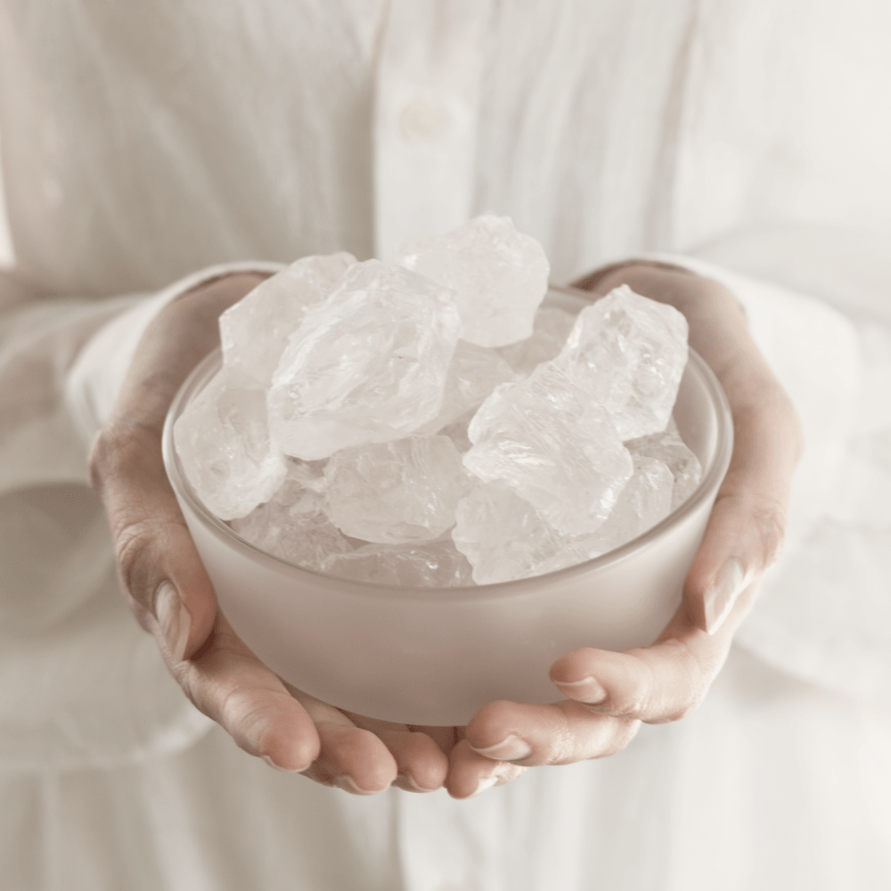 A person holding the Airy Fragrances Stone Diffuser in two hands, showcasing the substantial scale of the 500g raw natural Clear Quartz stones and the minimalist frosted glass vessel. This Japanese-crafted aromatherapy set provides a localised scent experience for mental clarity and sophisticated Zen home styling.