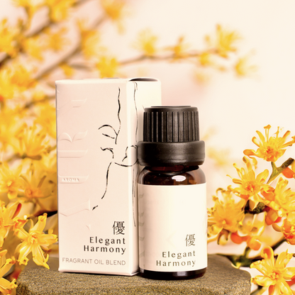 Elegant Harmony 優 (Yu) luxury fragrant oil styled with vibrant golden osmanthus flowers. The 10ml amber bottle and minimalist box featuring an elegant line art illustration are set against a backdrop of seasonal Japanese blooms. A Japanese-crafted, alcohol-free blend of white tea and osmanthus designed for the Airy Stone Diffuser ritual to evoke grace and quiet confidence