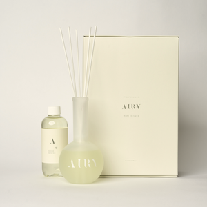 Serene Solstice 寧 luxury reed diffuser set inspired by Chiba Zen stone gardens. The image features the 250ml artisan fragrance oil with notes of Rose and Frankincense, the signature frosted glass vessel, and premium reeds. A grounding, alcohol-free Japanese scent designed for meditation spaces and master bedrooms.